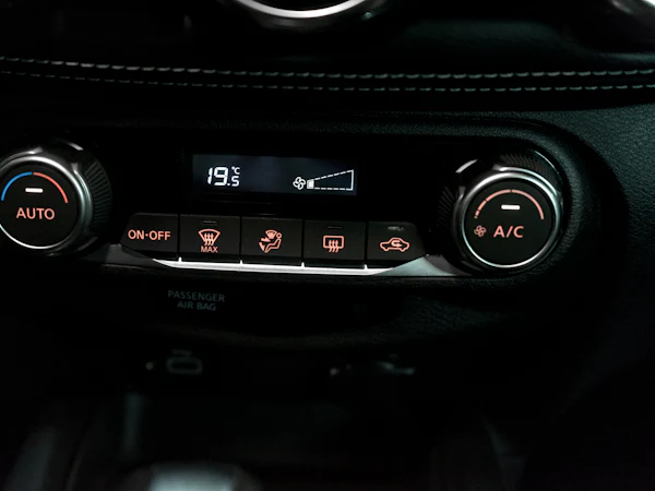A car climate control panel showing 19.5 degrees and the A/C button