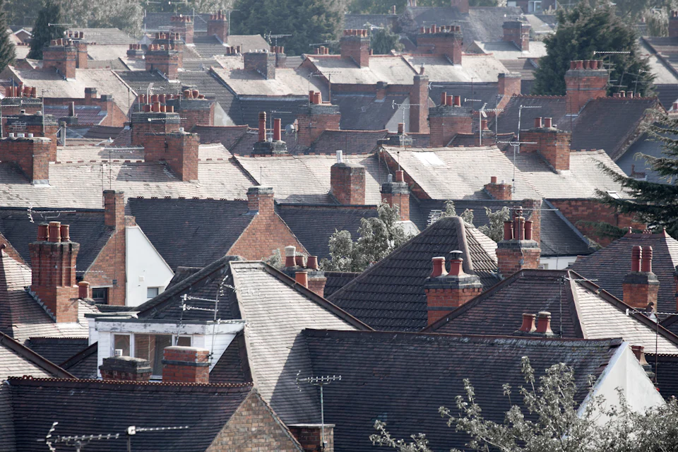 Rows of terraced roofs with brick chimney stacks and clay pots