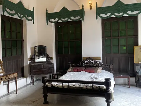 A room set under open roof timbers.