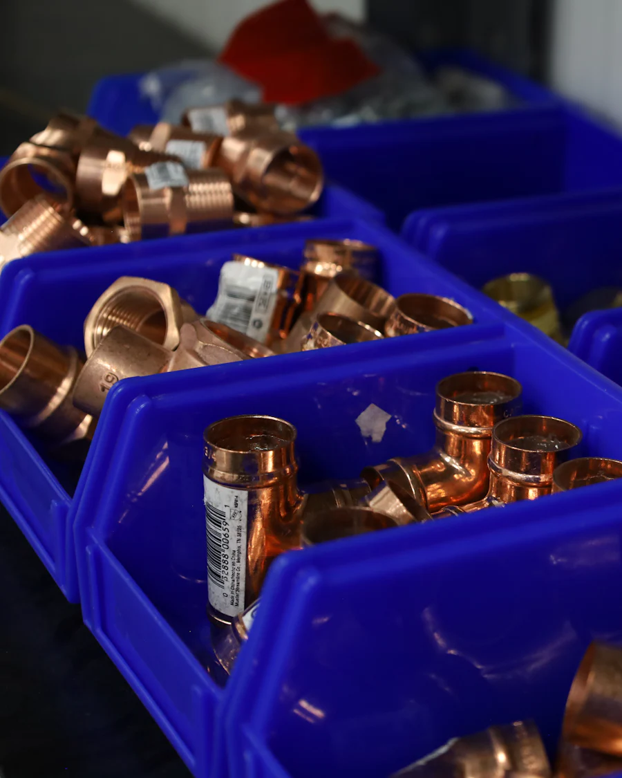 Blue parts bins full of copper elbows, tees and couplings