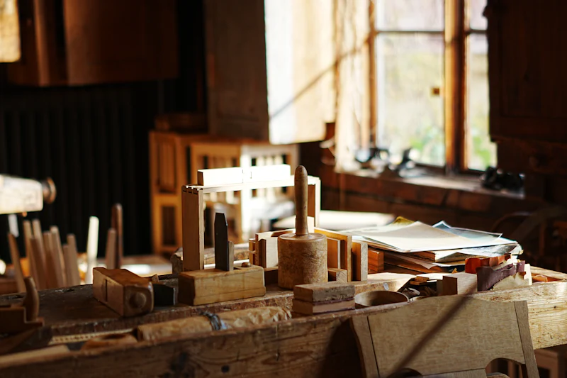 Wooden hand tools on an old workbench in a sunlit workshop