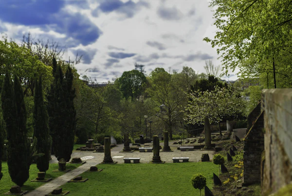 Chester’s Roman Gardens: lawns, columns and clipped trees under a cloudy sky