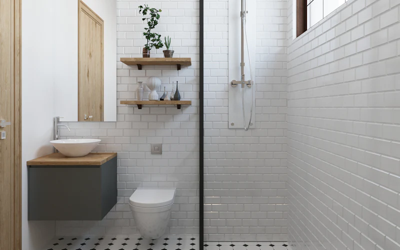 After: white metro tiles, a walk-in shower behind a glass panel, a floating basin and a black and white floor